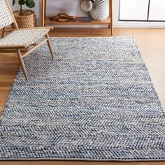 a living room with a chair and rug on the floor