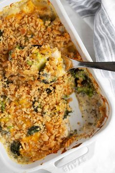 a casserole dish with broccoli and rice in it on a table