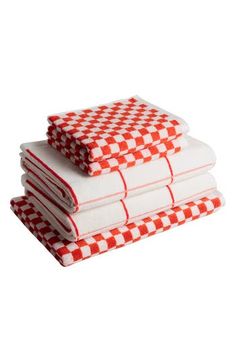 three red and white checkered napkins stacked on top of each other