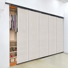 an open closet with sliding doors and shoes