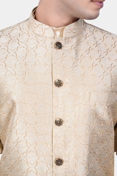 Introducing our exquisite Pearl Bush Cream hexagon Designer Embroidered Nehru Jacket, a fusion of traditional charm and contemporary elegance. Perfect for weddings, engagements, or any party occasion, this jacket exudes sophistication and style. Crafted with intricate embroidery, it adds a touch of regal flair to your ensemble. Versatile as casual wear, it pairs seamlessly with Kurta Jacket Sets, offering a refined Nehru Jacket option for men seeking timeless sophistication in their attire. In a Formal Nehru Jacket With Floral Embroidery And Straight Cut, Formal Nehru Jacket With Floral Embroidery And Straight Fit, Formal Straight Nehru Jacket With Floral Embroidery, Elegant Outerwear With Chikankari Embroidery, Elegant Straight Kurta With Chikankari Embroidery, Elegant Wedding Kurta With Gold Embroidery, Elegant Gold Embroidery Wedding Kurta, Wedding Bandhgala With Floral Embroidery And Long Sleeves, Formal Straight Kurta Bandhgala With Intricate Embroidery