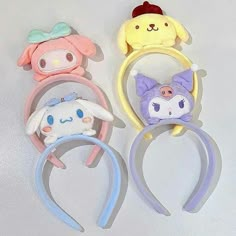 three different colored hair clips with animals on them