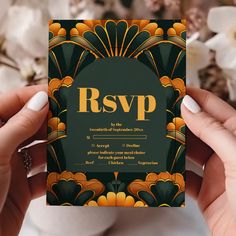 two hands holding up a green and orange wedding card with the word rsvp on it