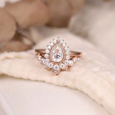 a diamond ring sitting on top of a white cloth