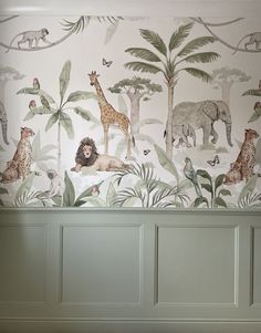 the wallpaper in this room has animals and plants on it