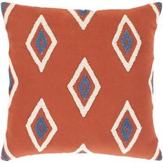 an orange and blue pillow with diamonds on it