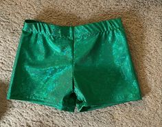 a pair of green shorts laying on the floor