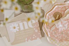 a table topped with plates and flowers next to each other