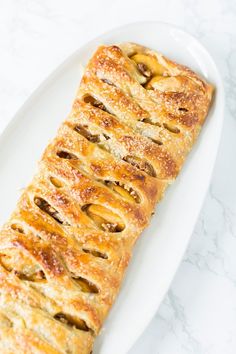 a white plate topped with pastry on top of a table