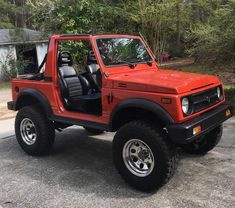 a red jeep parked in front of a house