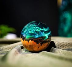 a glass ball sitting on top of a cloth