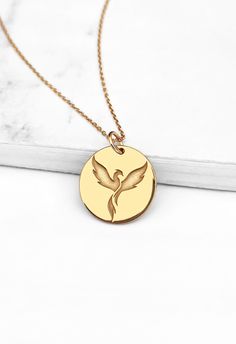 14K 9K Dainty Phoenix Bird necklace, Gold Firebird Necklace, Solid gold Charm necklace, Rebirth Renewal necklace, Minimalist Layering necklace, FREE EXPRESS SHIPPING A dainty disc necklace with an engraved phoenix bird made in solid 9K or 14K solid gold. Phoenix is a mythical firebird that rises from its ashes. It symbolizes rebirth, renewal and eternity and is also representative of hope. Whisper...Hope and Strength rises from the ashes! -------------------------------------------------- D E T Double Horn Necklace, Sun And Moon Necklace, Solid Gold Charms, Phoenix Bird, Symbol Necklace, Horn Necklace, Solid Gold Necklace, Gold Designs, Bird Necklace