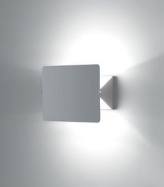 a wall light that is on the side of a wall with a square shaped surface