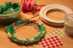 paper plate wreaths and other crafting supplies laid out on a table