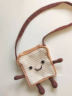 a crocheted piece of bread with a smiling face on it's side