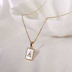 "This dainty monogram necklace is a timeless statement piece. The gold filled Pearl initial charm hangs from your choice of gold filled satellite chain with sterling silver beads or gold filled box chain.  Each necklace is 16\" and comes with a 2\" extender making it up to 18\" long.  The satellite chain provides the perfect amount of sparkle giving this necklace a more elegant feel. The box chain adds more depth which makes this piece a classic statement." The Satellite, Dana Point, Monogram Necklace, Initial Charm, Box Chain, Sterling Silver Bead, Initial Necklace, Silver Beads, Charm Necklace