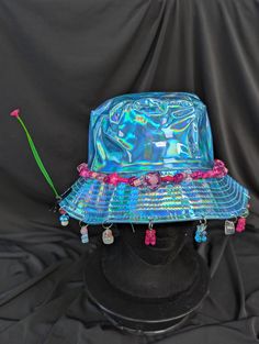 -hat color - blue -bead color - pink -charm color - blue and pink -unisex adult size -inner circumference - 22.5in -crown dip - 3in -brim - 2.25in -NOT machine washable -Perfect for raves and outdoor festivals! Shipping within the US USPS First Class Package 3-9 days USPS Priority Mail 1-5 days USPS Priority Mail Express 1-3 days Shipping International  USPS First Class Mail International  -Varies- USPS Priority Mail International 6-14 days USPS Priority Mail Express International 3-9 days Shipping times are estimated, NOT GUARENTEED.  +International buyers are responsible for all import fees+ +Orders of $50+ may require signature confirmation upon delivery+ Pink Charm, Bucket Hats, Blue And Pink, Blue Beads, Priority Mail, Caps Hats, Bucket Hat, Accessories Hats, Blue White