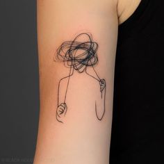 a woman's arm with a black and white line drawing on the back of it