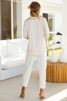 Length from shoulder to hem of size S: 64cm. Ivory shirt. Non-lined. Cold hand wash only. Model is a standard XS and is wearing size XS. True to size. Lightweight and slightly stretchy woven satin with sheen. Button-through front. 100% Polyester. Designed in Australia. For #bossbabes who love serving serious sophisticated vibes or exude unending elegance all hours of the day, the Cheyenne Shirt by LIONESS is a definite wardrobe addition. Made of luxe and slightly stretchy satin, this day to date Chic White Shirt For Loungewear, Elegant White Blouse For Loungewear, Elegant Tops With Shirttail Hem For Day Out, Elegant Shirttail Hem Tops For Day Out, Elegant Cream Stretch Blouse, Cream Relaxed Fit Blouse For Day Out, Relaxed Fit Cream Blouse For Day Out, Chic Cream Shirt For Day Out, Chic Cream Shirt With Relaxed Fit