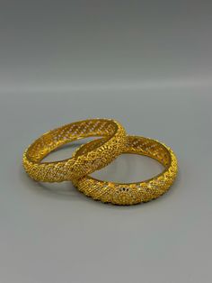 Embrace the allure of South Asian craftsmanship with our exquisite Gold-Plated Bangles. Inspired by the intricate designs of Indian, Pakistani, and Nepali jewellery, these bangles radiate elegance and charm. The smooth gold plating adds a touch of luxury to your ensemble, making them a versatile accessory for any occasion. Whether you're attending a wedding, celebrating a festival, or simply want to elevate your everyday style, these bangles effortlessly enhance your look with their timeless beauty. Experience the fusion of tradition and contemporary fashion with our stunning Gold-Plated Bangles. Next day delivery within uk can be arranged upon request.  We provide worldwide shipping as well. Contact us if you're interested and we will find you the fastest and the best quote. No return or Hoop Bangle For Wedding, Motif Jewelry For Celebrations, Elegant Festive Bangle As Gift, Elegant Festive Bangle Gift, Elegant Openable Bangle For Celebration, Elegant Cutdana Bracelets For Festive Season, Metal Bracelet With Intricate Design For Weddings, Elegant Cutdana Bracelets For Festive Occasions, Metal Bracelets With Intricate Design For Wedding