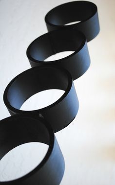 four black rings sitting on top of a table