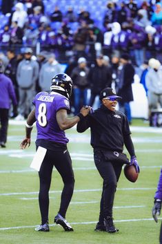 two football players on the field during a game