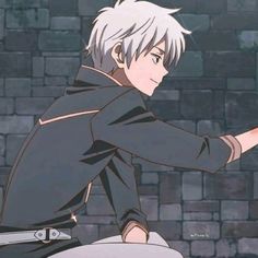 an anime character with white hair pointing at something in front of him on a brick wall