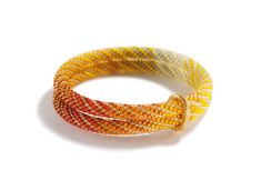 an orange and yellow bracelet on a white background