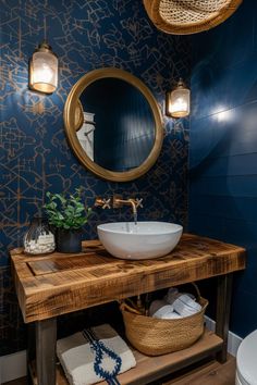 a bathroom with blue walls and a wooden vanity topped with a white bowl under a round mirror