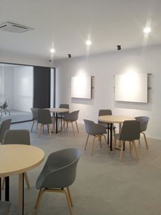 an empty meeting room with tables and chairs