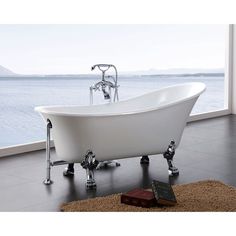 a white bath tub sitting on top of a black floor