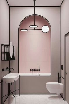 a bathroom with pink walls and white fixtures