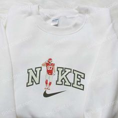 Introducing the Travis Kelce x Nike Embroidered Shirt, a must-have for NFL fans and fashion enthusiasts alike. This NFL Sport Embroidered T-shirt showcases the perfect blend of style and comfort. Made with premium quality materials, it offers a soft and breathable feel, ensuring all-day comfort. The embroidered design adds a touch of sophistication and showcases your love for the sport. This shirt is not only a great addition to your wardrobe but also makes for one of the best gift ideas for fam Casual Embroidered Crew T-shirt, Embroidered Cotton Crew T-shirt, Game Day White Sweatshirt With Embroidered Graphics, White Team Spirit Sweatshirt With Embroidered Graphics, White Game Day Sweatshirt With Embroidered Graphics, White Sweatshirt With Embroidered Graphics For Team Spirit, Collegiate Embroidered Crew Neck T-shirts, Sporty Embroidered Crew Neck T-shirt, White Embroidered Logo Top For College