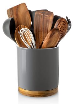 wooden utensils are in a metal cup