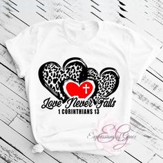 This stylish Love Never Fails Tee is sure to keep you comfortable and looking great. Show your faith and style with this white T-shirt, featuring a meaningful message inspired by 1 Corinthians 13:13. The tee is available in sizes small to 2XL, perfect for any individual. Share your love with the world in this lovely tee! Inspirational Letter Print White T-shirt, Inspirational White T-shirt With Letter Print, Inspirational White Pre-shrunk T-shirt, Inspirational White Tops With Custom Print, Inspirational White Top With Custom Print, Inspirational White Graphic Print T-shirt, Inspirational Custom Print White Top, Comfy Jeans, Love Never Fails