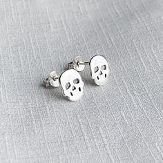 Real 925 Sterling Silver Tiny Skull Stud Earrings These lovely earrings can be used in Earlobe, Tragus and Cartilage. Measures 9x8mm Comes with pushback backings Sold by Pair Jewelry will come in a gift box * Please read shop policy before placing an order * *JEWELRY CARE* Sterling Silver will tarnish over time, but to help keep your jewelry looking beautiful - Clean with a soft dry cloth after wear and store inside an airtight bag or container. Remember to remove your jewelry when: * Applying l White Sterling Silver Skull Jewelry, White Skull-shaped Sterling Silver Jewelry, Nickel-free Sterling Silver Skull Jewelry, Minimalist Skull Jewelry Gift, Silver Skull Earrings For Pierced Ears, Sterling Silver Skull Earrings For Gift, Handmade Sterling Silver Skull Earrings, Silver Skull Earrings, Second Hole Piercing