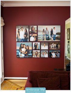 a living room with red walls and pictures hanging on the wall, along with a couch