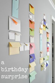 a wall with post it notes attached to it and the words make a birthday surprise on it