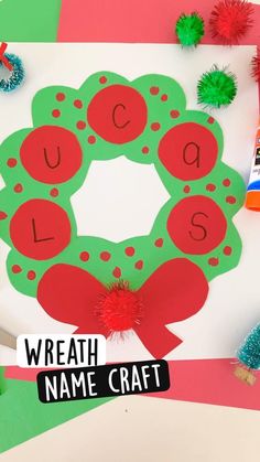 a wreath name craft with pom poms on it