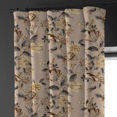 a curtain with flowers on it in front of a window