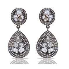 A dazzling melange of Diamonds in contrasting grey and white hues in a contemporary interpretation of classic Jaipur design on the most spectacular chandelier earrings.- Grey Diamonds weight approx 2.80 Carats.- White Diamonds weight approx 1.80 Carats.- Set in Blackened Oxidized Silver. Luxury Teardrop Diamond Earrings With Single Cut Diamonds, Luxury Rose Cut Drop Diamond Earrings, Hand Set Diamond White Teardrop Diamond Earrings, Hand Set Diamond White Teardrop Earrings, Hand-set White Diamond Teardrop Earrings, Luxury Silver Chandelier Earrings With Rose Cut Diamonds, Diamond White Teardrop Rose Cut Diamond Earrings, Diamond White Rose Cut Drop Earrings, Black Diamond Drop Earrings