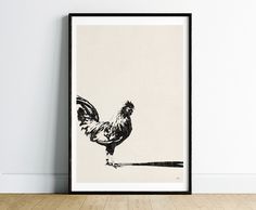 a black and white photo of a chicken on a wall next to a wooden floor