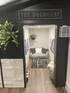 the doghouse is decorated in black, white and grey colors with an indoor plant