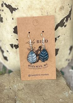 Add a touch of nature, whimsy, and craftsmanship to your jewelry collection with our blue etched glass leaf design earrings. These exquisite beads are meticulously crafted in the Czech Republic, known for its centuries-old glassmaking tradition. Each bead features intricate etching that creates a textured, frosted look, adding depth and character to your pendant earrings. Ideal for pendant earrings, these lightweight beads are easy to work with, offering a refined, vintage-inspired aesthetic tha Blue Leaf-shaped Jewelry Gift, Blue Leaf-shaped Jewelry For Gift, Nature-inspired Blue Dangle Earrings, Blue Nature-inspired Drop Earrings, Etched Blue Jewelry For Gift, Handmade Blue Leaf-shaped Jewelry, Unique Blue Etched Jewelry, Unique Etched Blue Jewelry, Leaf Design Earrings