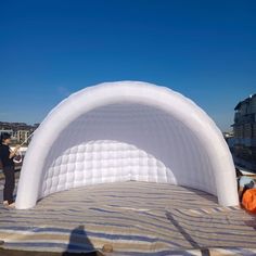 an inflatable bed is set up on the beach for people to enjoy it