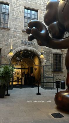 a large metal sculpture in front of a building