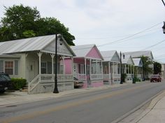 a row of houses with pink and white sidings