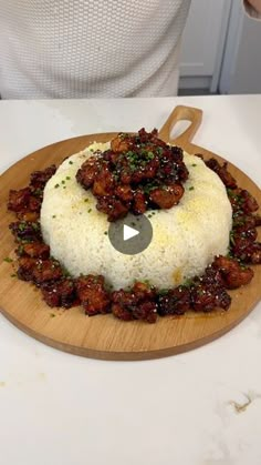 a person sitting at a table with a plate of food on it and the video is being viewed