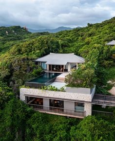 an aerial view of a house surrounded by trees