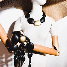 Multistrand bold necklace. Four strands of matte black and gold beads Multi-strand Gold Jewelry With Wooden Beads, Gold Multi-strand Jewelry With Wooden Beads, Black Multi-strand Wooden Bead Necklaces, Black Multi-strand Wooden Beaded Necklaces, Black Multi-strand Wooden Beads Jewelry, Black Multi-strand Necklace, Elegant Multi-strand Necklaces With Wooden Beads, Elegant Multi-strand Necklace With Wooden Beads, Black Jewelry With Large Beads